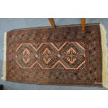 A small Persian rug 110cm x 60cm.