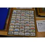 Players cigarette cards depicting cars, aeroplanes and military figures, set of four framed and