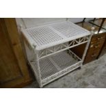 A white painted faux bamboo two tier trolley.