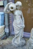 A good large composite garden statue modelled as a classical female semi nude with an urn on her