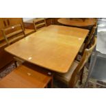 A G plan teak drop leaf gateleg dining table with four ladderback chairs.