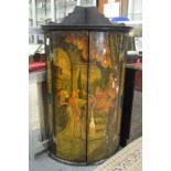 A George III lacquer bow front hanging corner cupboard with painted decoration depicting a classical