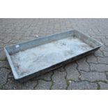 A rectangular galvanised trough or planter.