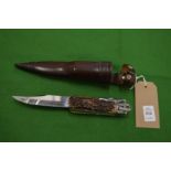 A Linder 'Wolf' no:317119 folding knife with stag horn handle, and 7in blade with leather scabbard.