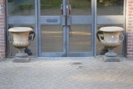 A good pair of Campagna shaped twin handled garden urns on square bases.