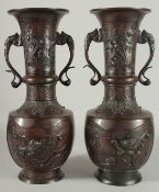 A LARGE PAIR OF JAPANESE BRONZE TWIN HANDLE VASES, with relief decoration depicting birds on