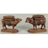 TWO FINE 19TH CENTURY ANGLO INDIAN CARVED WOODEN BUFFALO SHAPED COASTERS / STANDS, each approx. 24cm