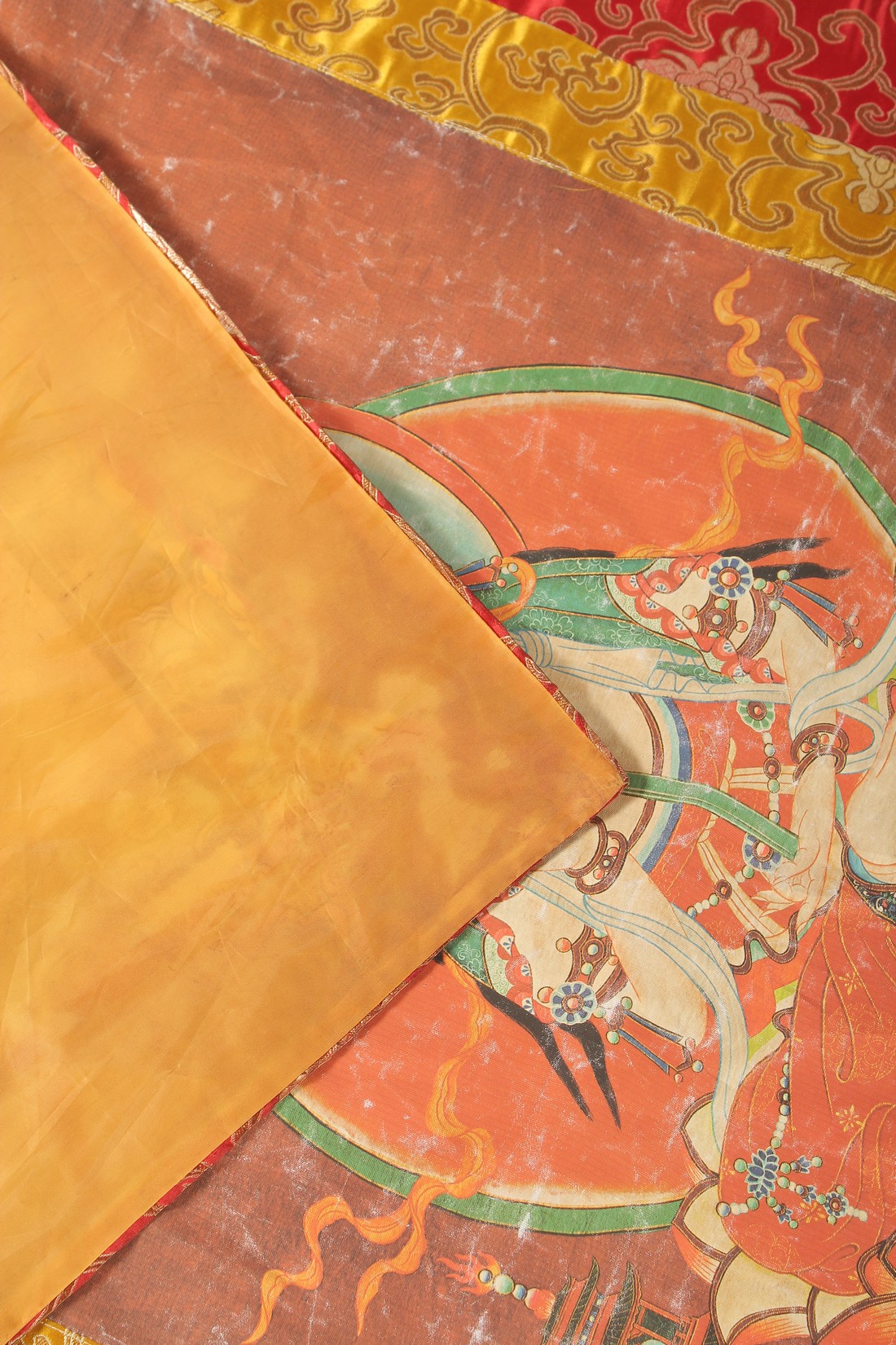 A TIBETAN THANGKA MOUNTED ON SILK. - Image 3 of 3