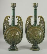 A PAIR OF 19TH CENTURY GREEN HISPANO-MORESQUE GLAZED CERAMIC CANDLESTICKS / VASES, 60cm high.