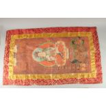 A TIBETAN THANGKA MOUNTED ON SILK.