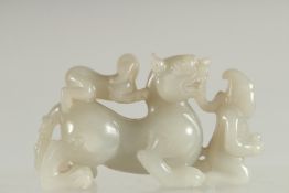 A CHINESE CARVED JADE KYLIN PAPERWEIGHT, 12cm long.