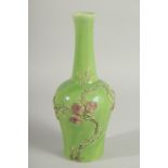 A CHINESE GREEN GROUND CARVED PEACH VASE, with fine moulded and carved relief decoration around