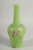 A CHINESE GREEN GROUND CARVED PEACH VASE, with fine moulded and carved relief decoration around