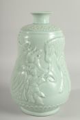 A CHINESE CELADON GLAZE PORCELAIN VASE, the body carved with figures and a horse, 33cm high.