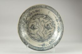 A LARGE CHINESE WANLI BLUE AND WHITE DISH, painted with flora, (repair), 39.5cm diameter.