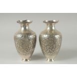 A PAIR OF EARLY 20TH CENTURY SIGNED PERSIAN SILVER VASES, with fine embossed and engraved decoration