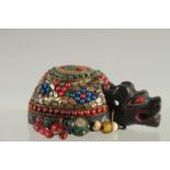 A TIBETAN ABALONE INLAID FIGURE OF A TORTOISE, inset with various other beads, 9cm long.