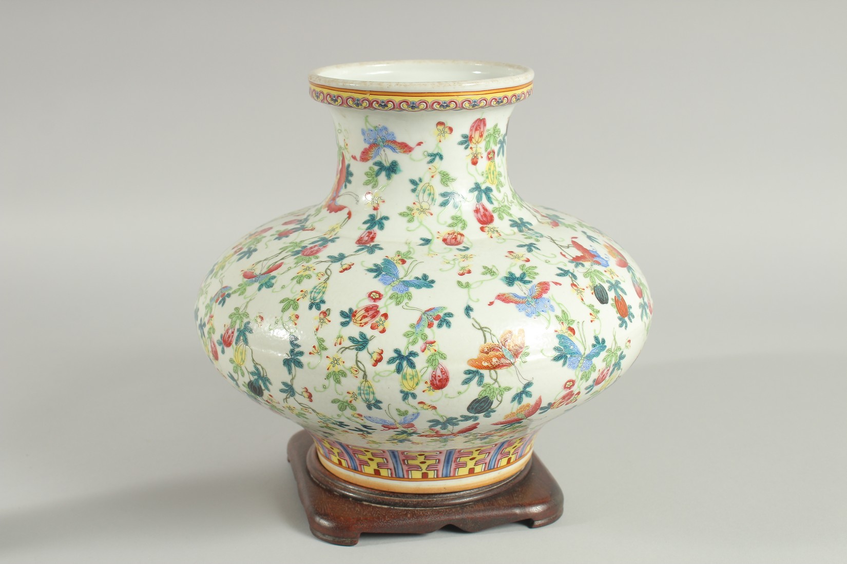 A CHINESE FAMILLE ROSE PORCELAIN SQUAT-FORM VASE and hardwood stand, the vase decorated all over - Image 2 of 6