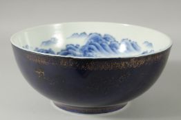A LARGE CHINESE BLUE AND WHITE PORCELAIN BOWL, the interior painted with a continuous mountainous