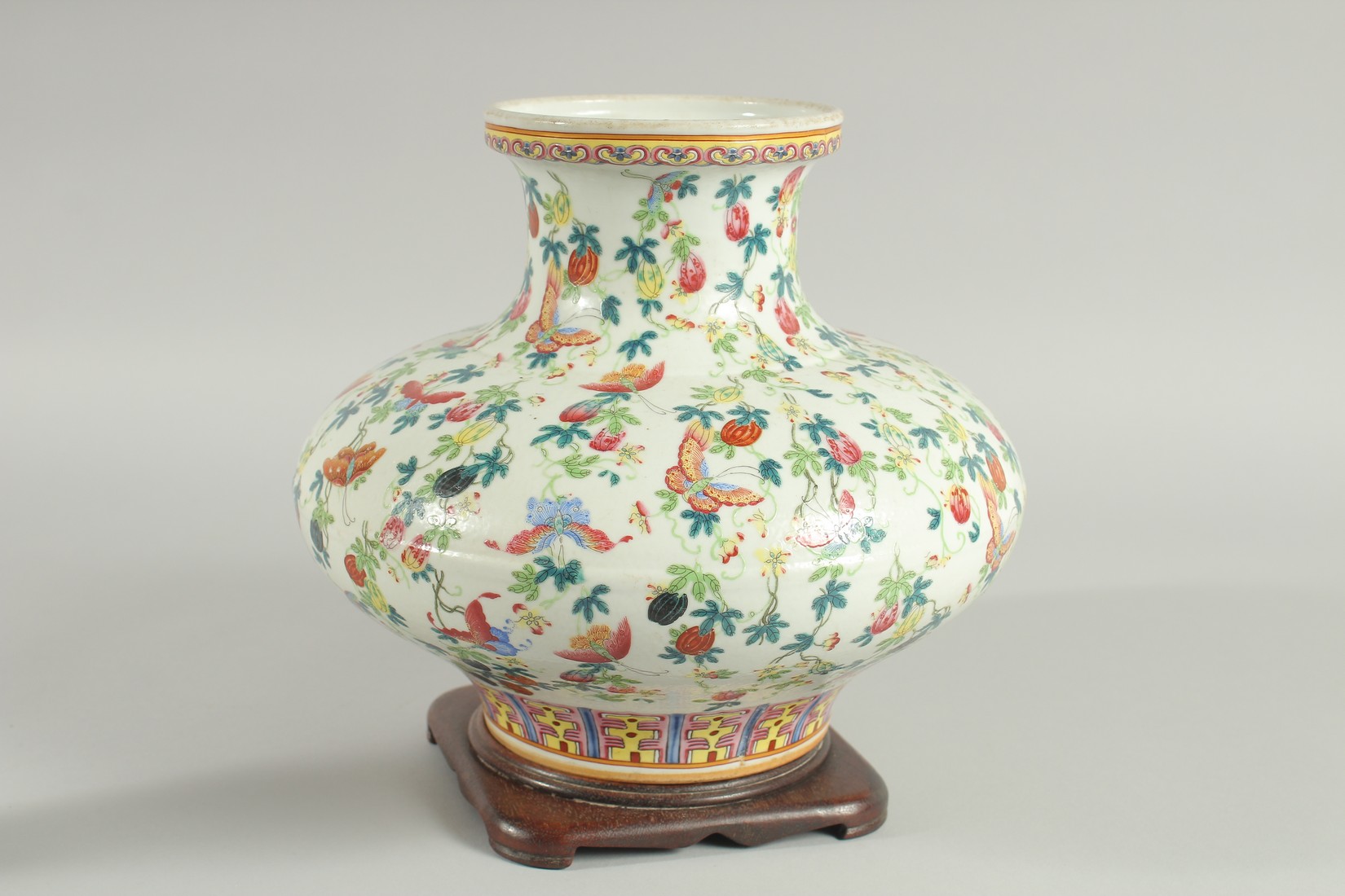 A CHINESE FAMILLE ROSE PORCELAIN SQUAT-FORM VASE and hardwood stand, the vase decorated all over - Image 4 of 6