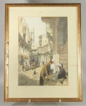 A LITHOGRAPH PRINT OF A TURKISH STREET SCENE, framed and glazed, image 49cm x 35cm.