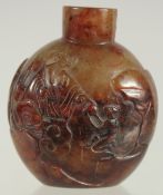 A FINE CHINESE CARVED HARDSTONE SNUFF BOTTLE, one side carved with an immortal and monkey, the