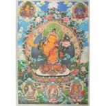 A TIBETAN THANGKA MOUNTED ON PAPER.