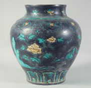 A LARGE CHINESE FAHUA-TYPE PORCELAIN JAR, painted with flowers and lucky symbols, 34cm high.