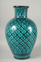 A LARGE ARABIC TURQUOISE GLAZED POTTERY VASE, signed to the base, 42cm high.