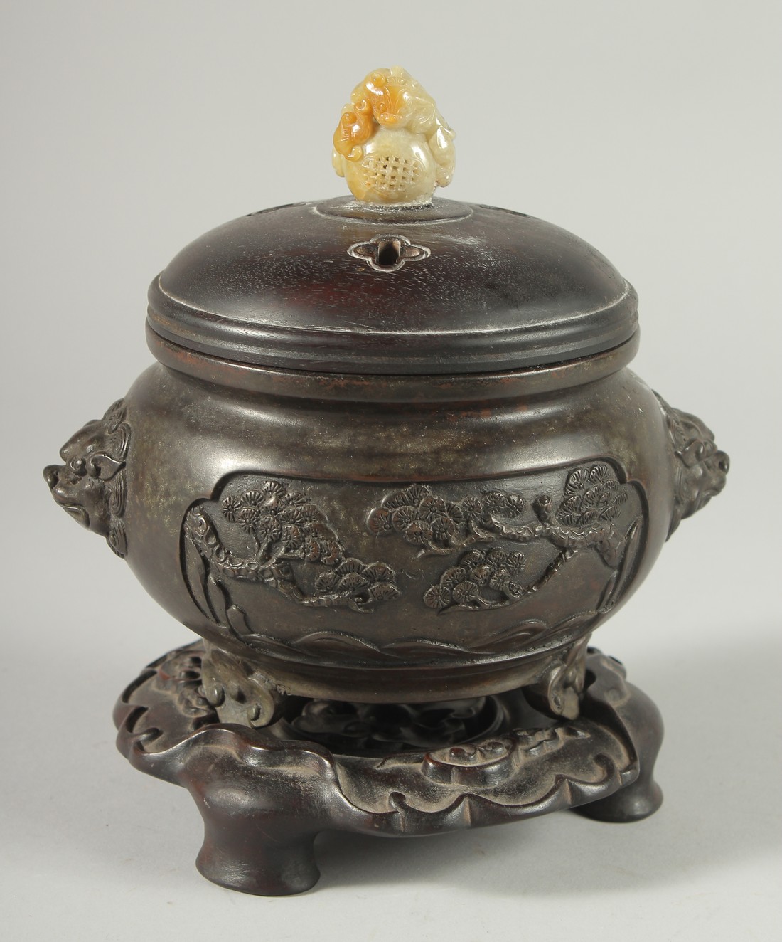 A CHINESE ARCHAIC STYLE BRONZE CENSER WITH CARVED JADE MOUNTED HARDWOOD COVER, on a fitted