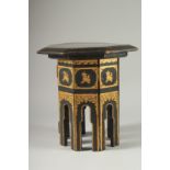 A SMALL BLACK AND GILT LACQUERED OCTAGONAL TABLE.