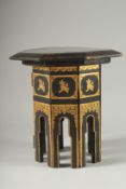 A SMALL BLACK AND GILT LACQUERED OCTAGONAL TABLE.