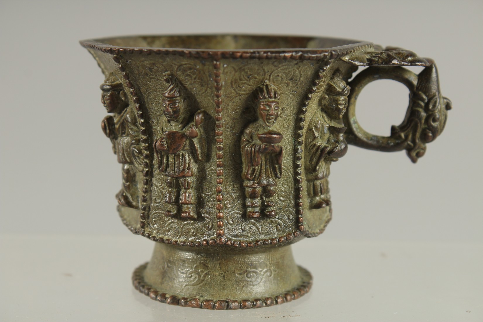 A CHINESE BRONZE CUP WITH RELIEF CAST FIGURES, mark to base possibly Da Tang Zhen Guan (true - Image 3 of 6