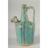 A KASHAN STYLE TURQUOISE GLAZED POTTERY EWER, with zoomorphic spout, 28.5cm high.