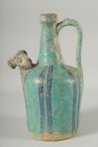 A KASHAN STYLE TURQUOISE GLAZED POTTERY EWER, with zoomorphic spout, 28.5cm high.