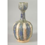 A KASHAN STYLE GLAZED POTTERY VASE, the body of ribbed form with panels of