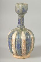 A KASHAN STYLE GLAZED POTTERY VASE, the body of ribbed form with panels of