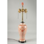 A CHINESE COPPER RED AND WHITE PORCELAIN VASE LAMP, painted with floral motif decoration, the lamp