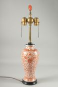 A CHINESE COPPER RED AND WHITE PORCELAIN VASE LAMP, painted with floral motif decoration, the lamp