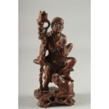 A CHINESE CARVED HARDWOOD FIGURE, 25.5cm high.