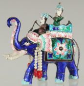 AN EARLY 20TH CENTURY INDIAN BENARES ENAMELLED SILVER ELEPHANT, 10cm long.