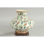 A CHINESE FAMILLE ROSE PORCELAIN SQUAT-FORM VASE and hardwood stand, the vase decorated all over