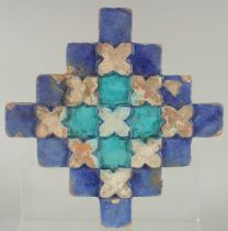 A FINE 18TH-19TH CENTURY INDIAN MULTAN GLAZED POTTERY TILE, with raised geometric design, 23cm x