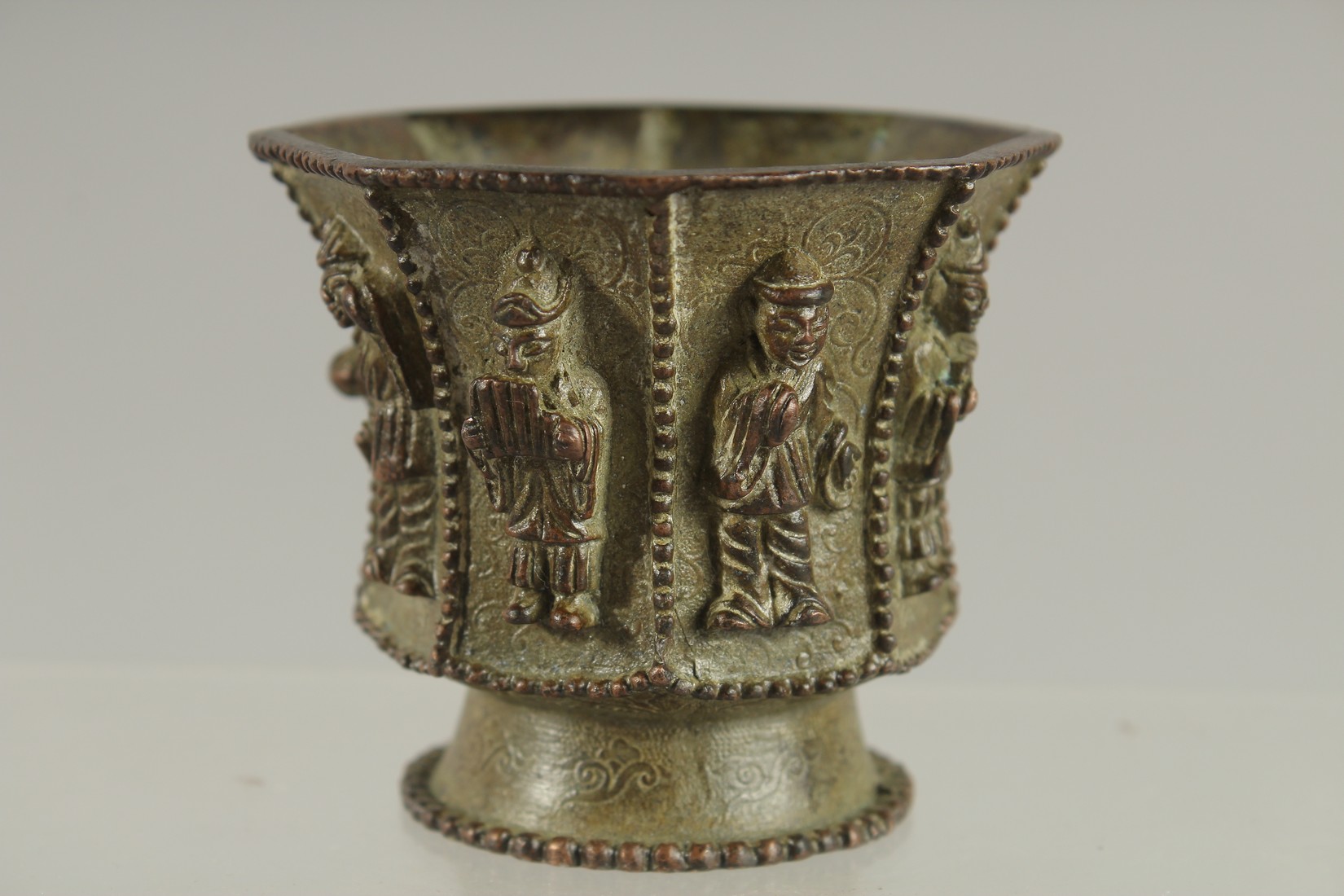 A CHINESE BRONZE CUP WITH RELIEF CAST FIGURES, mark to base possibly Da Tang Zhen Guan (true - Image 4 of 6
