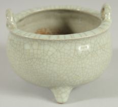 A CHINESE CELADON CRACKLE GLAZE TWIN HANDLE TRIPOD CENSER, 10.5cm diameter.