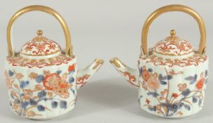 A FINE PAIR OF CHINESE IMARI PORCELAIN TEAPOTS, painted in the typical Imari palette with blue,