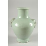 A CHINESE CELADON GLAZED VASE, with moulded drop ring handles, the base with character mark, 25.