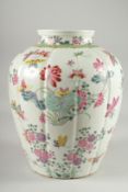 A LARGE CHINESE FAMILLE ROSE PORCELAIN VASE, painted with flora and butterflies, 34cm high.