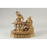 A LARGE GILT BRONZE FIGURE OF TWO DEITIES ON AN OVAL DOUBLE-LOTUS BASE, 28cm wide.
