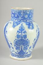 AN OTTOMAN TURKISH BLUE AND WHITE GLAZED POTTERY VASE, 29cm high.